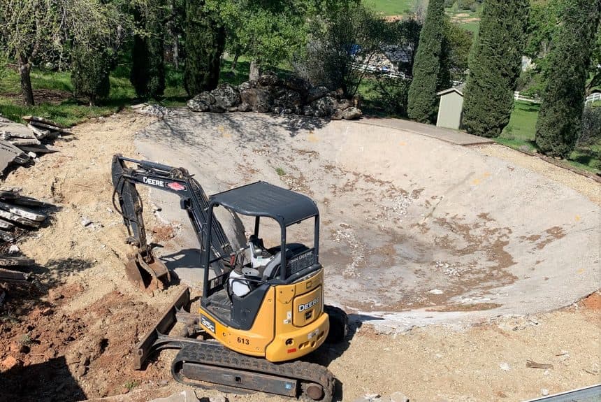 Excavator digging the pool shape
